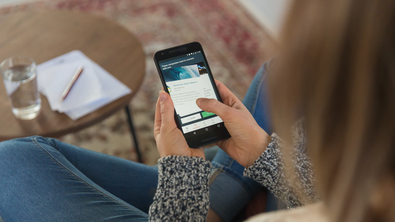 Person holding a smartphone and filling in an online form