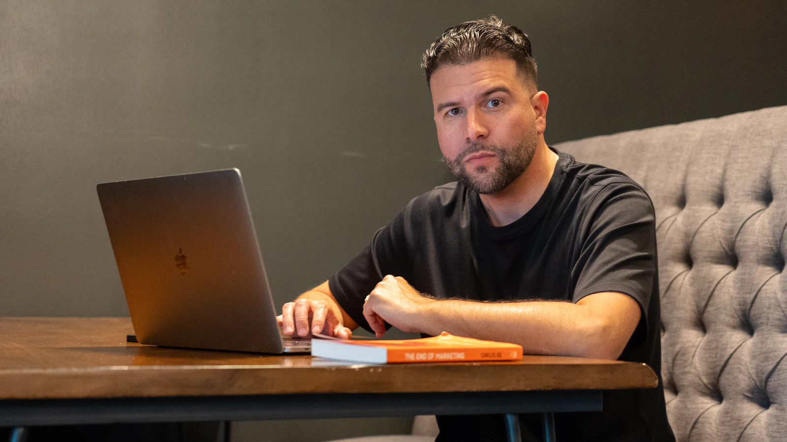 Business owner sitting at a desk with a laptop