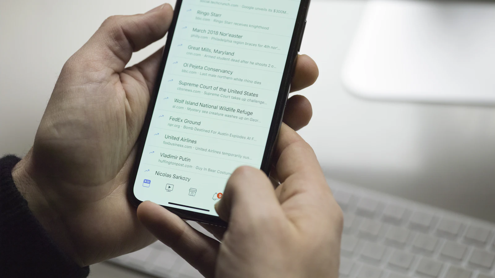 Hands holding a smartphone showing a simple mobile web page