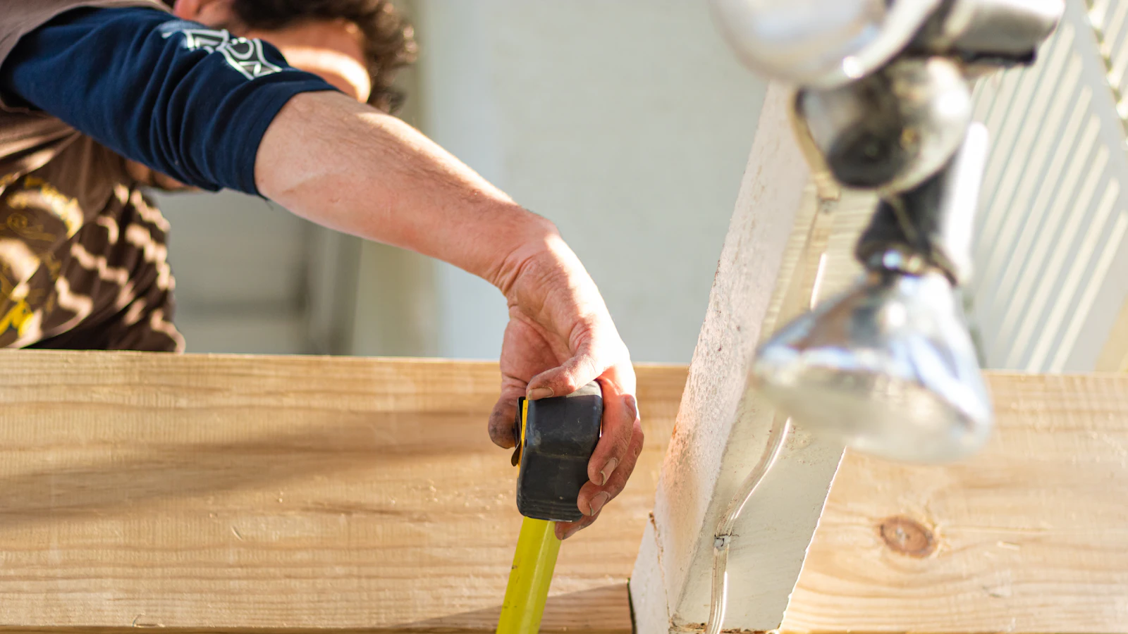Hand using a tape measure to take a measurement