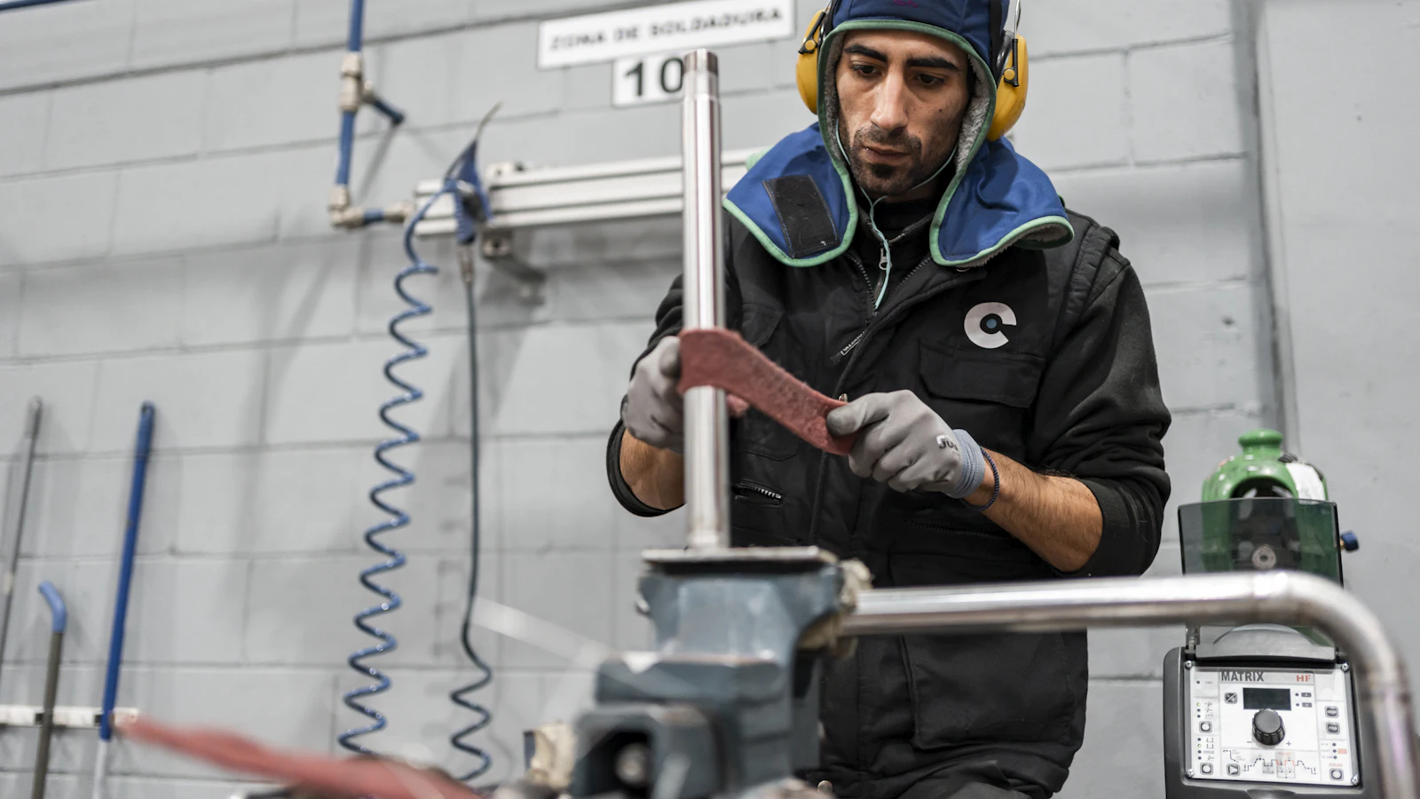 Technician in safety gear working on equipment