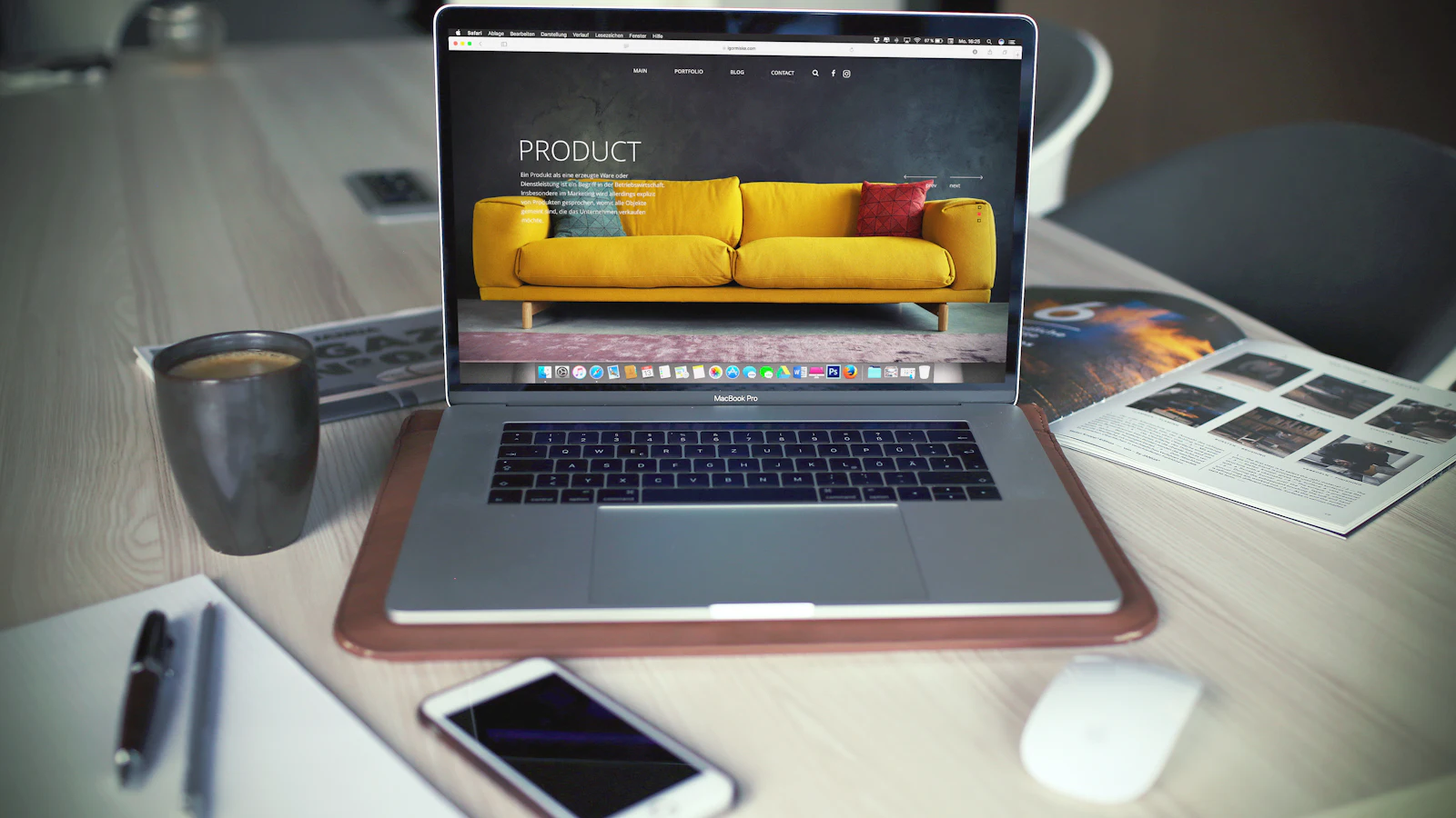 Laptop showing a website layout on a desk